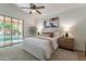 Bright bedroom featuring a ceiling fan and sliding glass door to the outside at 1807 W Canary Way, Chandler, AZ 85286
