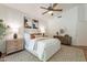 Bright bedroom with ceiling fan, matching nightstands, and textured rug at 1807 W Canary Way, Chandler, AZ 85286