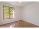 Bedroom with natural light from a large window and earthy-toned tile flooring throughout at 1807 W Canary Way, Chandler, AZ 85286