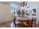 Sunlit dining area featuring tile floors, a round table, and views from the large window at 1807 W Canary Way, Chandler, AZ 85286