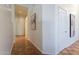 Hallway featuring warm-toned tile flooring and neutral decor at 1807 W Canary Way, Chandler, AZ 85286