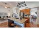 Open kitchen with granite island, stainless steel appliances, and seamless access to living spaces at 1807 W Canary Way, Chandler, AZ 85286