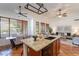 Bright kitchen with large island, modern appliances, and view into the dining and living area at 1807 W Canary Way, Chandler, AZ 85286