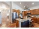 Open kitchen with granite island, stainless steel fridge, and seamless access to living spaces at 1807 W Canary Way, Chandler, AZ 85286