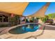 Private pool area in backyard, complete with shade sails, landscaping and BBQ area at 1807 W Canary Way, Chandler, AZ 85286