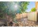 View of a low maintenance side yard featuring a stone pathway, secure gate, and storage shed at 1807 W Canary Way, Chandler, AZ 85286
