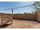 Fenced backyard featuring a wooden deck and clear blue skies at 1953 E Presidio Rd, Phoenix, AZ 85022