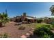 Large backyard with a mix of grass, desert landscaping, and a covered patio at 1953 E Presidio Rd, Phoenix, AZ 85022