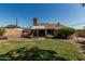 Spacious backyard with green lawn, shade trees, and patio area at 1953 E Presidio Rd, Phoenix, AZ 85022