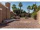 Private backyard featuring mature palm trees, desert landscaping, and covered hot tub at 1953 E Presidio Rd, Phoenix, AZ 85022