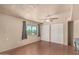 Bedroom features a ceiling fan, wood look floors, closet and natural lighting at 1953 E Presidio Rd, Phoenix, AZ 85022