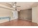 Bright bedroom features ceiling fan, wood-look floors, and vintage blue accent table at 1953 E Presidio Rd, Phoenix, AZ 85022
