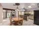 Bright dining area featuring tile floors, view of the fireplace, and an adjacent kitchen at 1953 E Presidio Rd, Phoenix, AZ 85022
