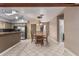 Charming dining area featuring a wood table, lovely chandelier, and seamless access to the kitchen and living room at 1953 E Presidio Rd, Phoenix, AZ 85022