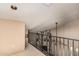 Hallway with metal railing overlooking the lower level with a ceiling fan at 1953 E Presidio Rd, Phoenix, AZ 85022