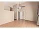 Open living room with high ceilings, ceiling fan, wood-look flooring, and bright natural light at 1953 E Presidio Rd, Phoenix, AZ 85022