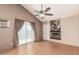 Cozy living room with a fireplace and sliding glass doors to the outside area, providing ample natural light at 1953 E Presidio Rd, Phoenix, AZ 85022