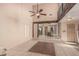 Bright, open living space with tile flooring, ceiling fan, and view into the dining and kitchen area at 1953 E Presidio Rd, Phoenix, AZ 85022