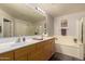 Large bathroom featuring double sinks, a soaking tub, a glass-enclosed shower, tile floors, and neutral colors at 19700 N 76Th St # 1040, Scottsdale, AZ 85255