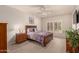 Inviting bedroom featuring carpeted floors, a ceiling fan, shuttered windows, and tasteful decor at 19700 N 76Th St # 1040, Scottsdale, AZ 85255