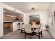 Elegant dining room with modern lighting, stylish chairs, and seamless flow to the kitchen at 19700 N 76Th St # 1040, Scottsdale, AZ 85255