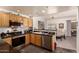 Cozy kitchen featuring wood cabinets, granite countertops, and stainless steel appliances, adjoining an informal dining area at 19700 N 76Th St # 1040, Scottsdale, AZ 85255
