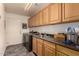 Convenient laundry room boasts ample cabinet space, modern washer, and a utility sink at 19700 N 76Th St # 1040, Scottsdale, AZ 85255