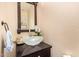 Powder room featuring a clear glass bowl sink on dark wood cabinet at 1991 S Bahama Dr, Gilbert, AZ 85295