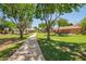 Scenic neighborhood park with lush green grass, walking path and mature trees offering plenty of shade at 1991 S Bahama Dr, Gilbert, AZ 85295