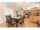 Dining area features a large dining table, open to the kitchen with stainless steel appliances at 1991 S Bahama Dr, Gilbert, AZ 85295