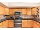 Updated kitchen with stainless steel appliances, wood cabinets, and dark countertops at 1991 S Bahama Dr, Gilbert, AZ 85295