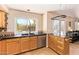 Kitchen featuring tiled floors, wooden cabinets, and backyard view at 1991 S Bahama Dr, Gilbert, AZ 85295
