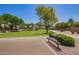 Neighborhood park featuring open green spaces, mature trees, and a bench for leisurely outdoor enjoyment at 1991 S Bahama Dr, Gilbert, AZ 85295