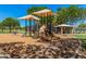 Well-maintained playground with slides, climbing features, and shaded areas for to enjoy at 1991 S Bahama Dr, Gilbert, AZ 85295