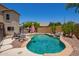 Relaxing backyard pool with a small waterfall feature, complemented by mature landscaping and lounge area at 1991 S Bahama Dr, Gilbert, AZ 85295