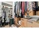 Spacious walk-in closet with built-in shelves and hanging racks offer ample storage at 1991 S Bahama Dr, Gilbert, AZ 85295