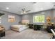 Neutral bedroom features plush carpet, a ceiling fan, natural light and ample desk space at 21813 N 40Th Way, Phoenix, AZ 85050