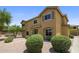 View of the two-story home featuring desert landscaping, exterior shutters, and beautiful shade trees at 21813 N 40Th Way, Phoenix, AZ 85050