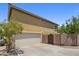 Tan two-story home with a two car garage and landscaped front yard at 21813 N 40Th Way, Phoenix, AZ 85050