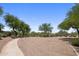 Community common area lined with gravel walkways and featuring natural desert landscaping and trees at 21813 N 40Th Way, Phoenix, AZ 85050