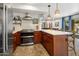 Bright kitchen area with stainless appliances, ample counter space, and an open layout to the living area at 21813 N 40Th Way, Phoenix, AZ 85050