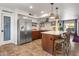 Modern kitchen with stainless steel appliances, white subway tile backsplash, and cozy breakfast bar at 21813 N 40Th Way, Phoenix, AZ 85050