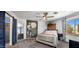 Relaxing main bedroom with ceiling fan, large bed, accent wall decor and an ensuite at 21813 N 40Th Way, Phoenix, AZ 85050