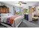 Spacious main bedroom with ceiling fan, TV, large bed, accent furniture and an ensuite at 21813 N 40Th Way, Phoenix, AZ 85050