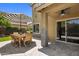 Outdoor patio features a dining table, striped umbrella, and stone accent wall at 21813 N 40Th Way, Phoenix, AZ 85050