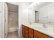 Bathroom featuring double sinks, wooden cabinets, and a shower-tub combination at 2230 E Whitten St, Chandler, AZ 85225