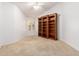 Bedroom featuring carpet flooring, ceiling fan, and floor-to-ceiling built-in bookshelves at 2230 E Whitten St, Chandler, AZ 85225