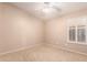 Simple room featuring carpet flooring, a ceiling fan, and a window with shutters at 2230 E Whitten St, Chandler, AZ 85225