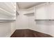 Spacious walk-in closet with custom white shelving and dark wood flooring at 2230 E Whitten St, Chandler, AZ 85225