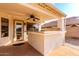Inviting covered patio with ceiling fan, built in bar and easy access to the yard at 2230 E Whitten St, Chandler, AZ 85225